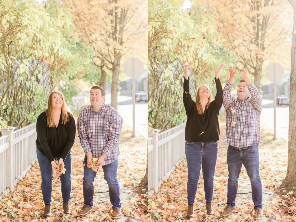 Couple throwing fall leaves in the air