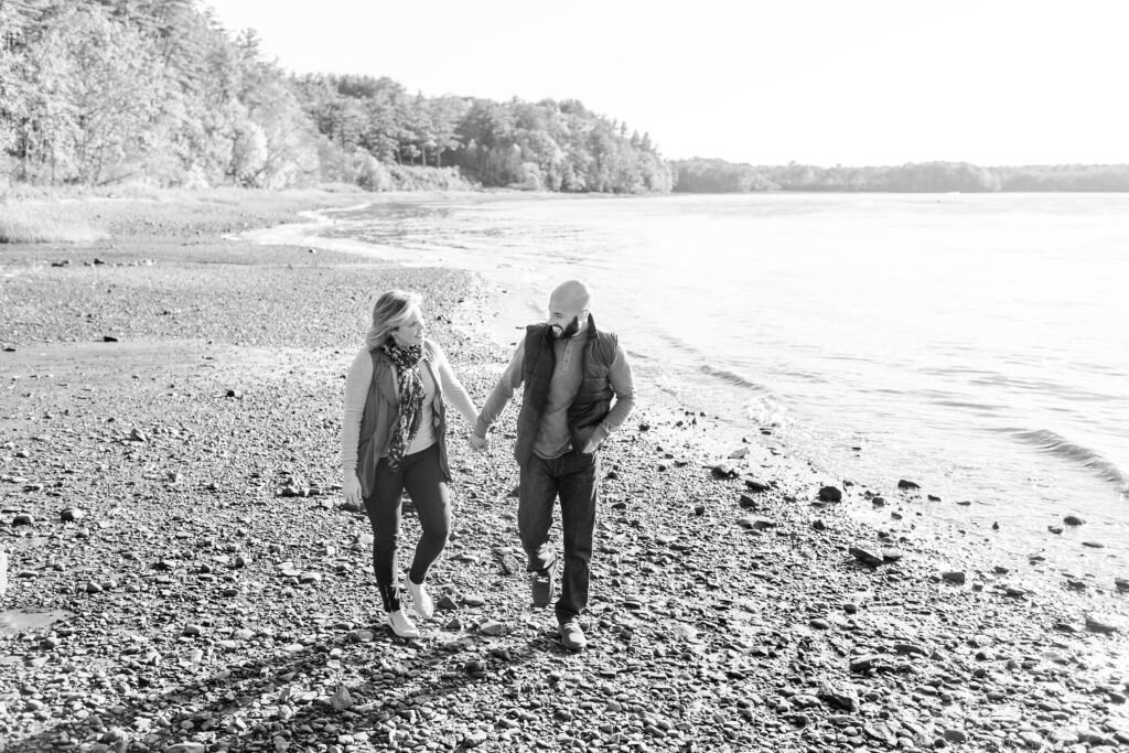 Black and white photo of couple walking on the beach