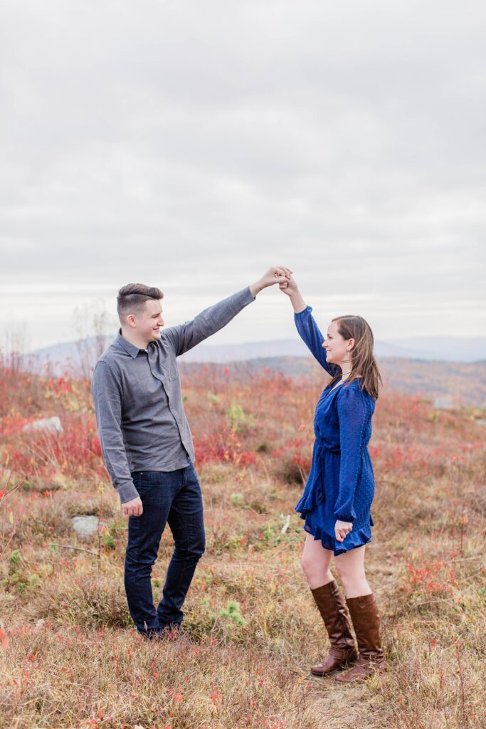 Couple dancing together on top of mountain
