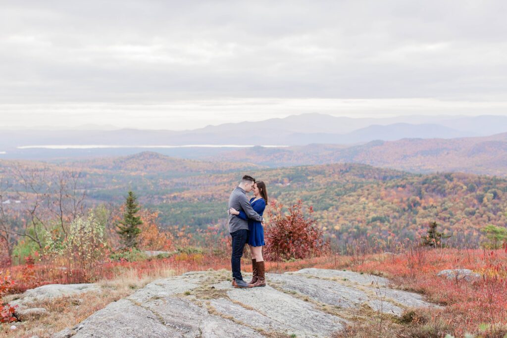Couple standing on top of mountain together