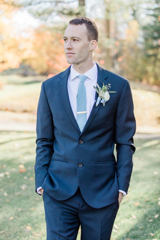 Groom standing in blue suit