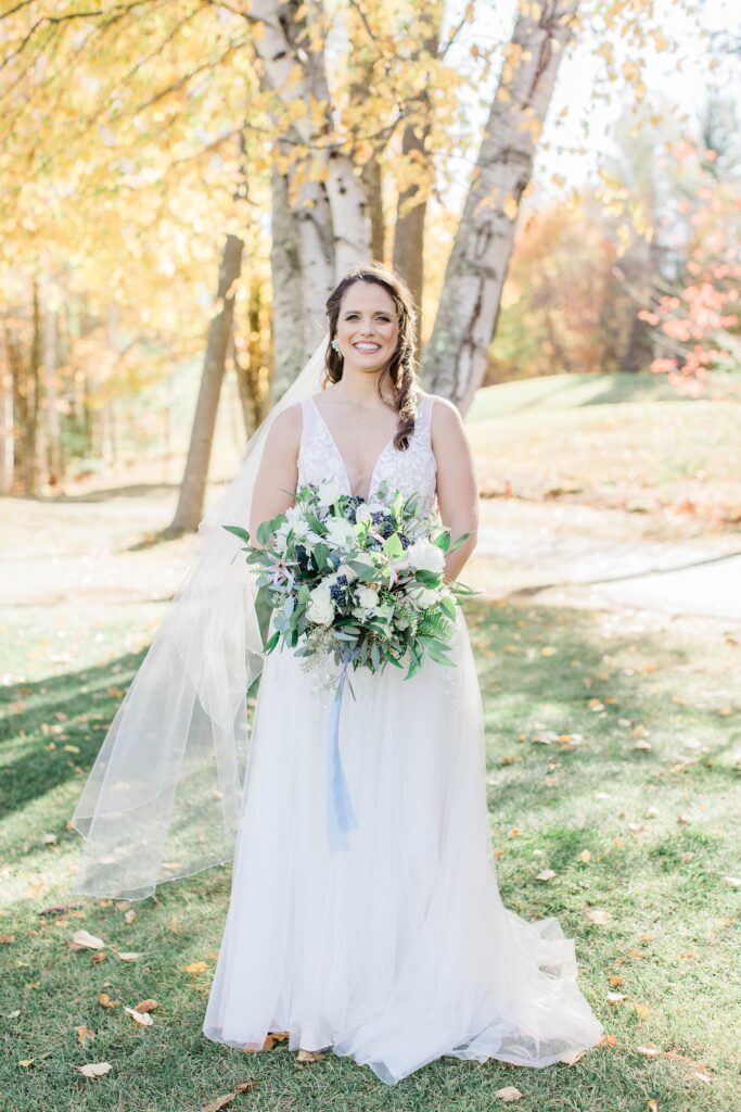 Bride standing in front of birches