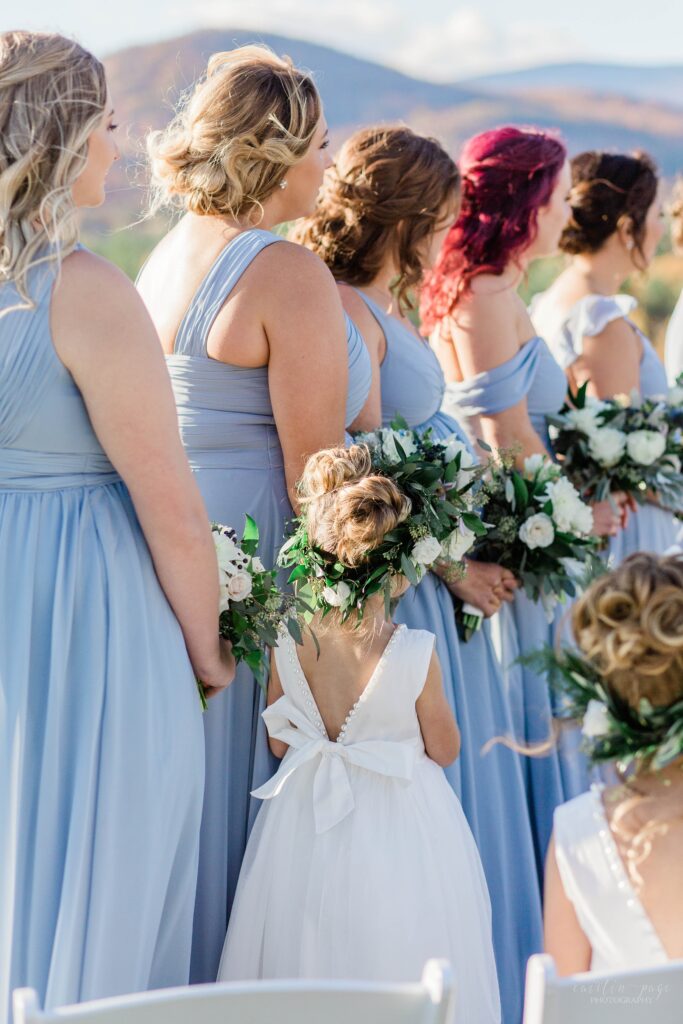 Flower girl holding bridesmaids hand