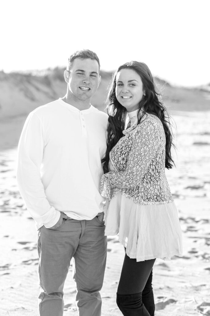 Black and white photo of couple standing together on the beach