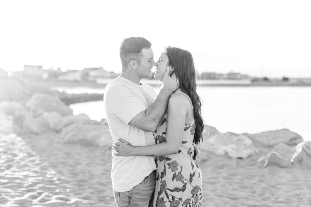 Black and white photo of couple kissing on beach