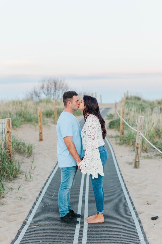 Man and woman kissing on boardwalk