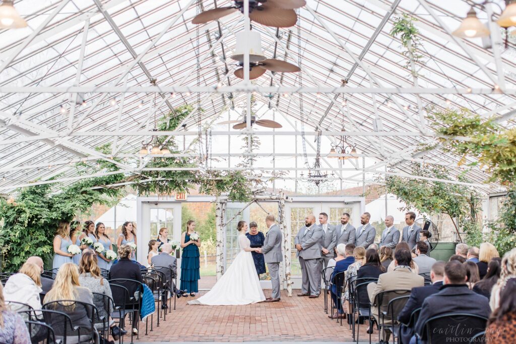 Wedding ceremony in the greenhouse at Barn on the Pemi