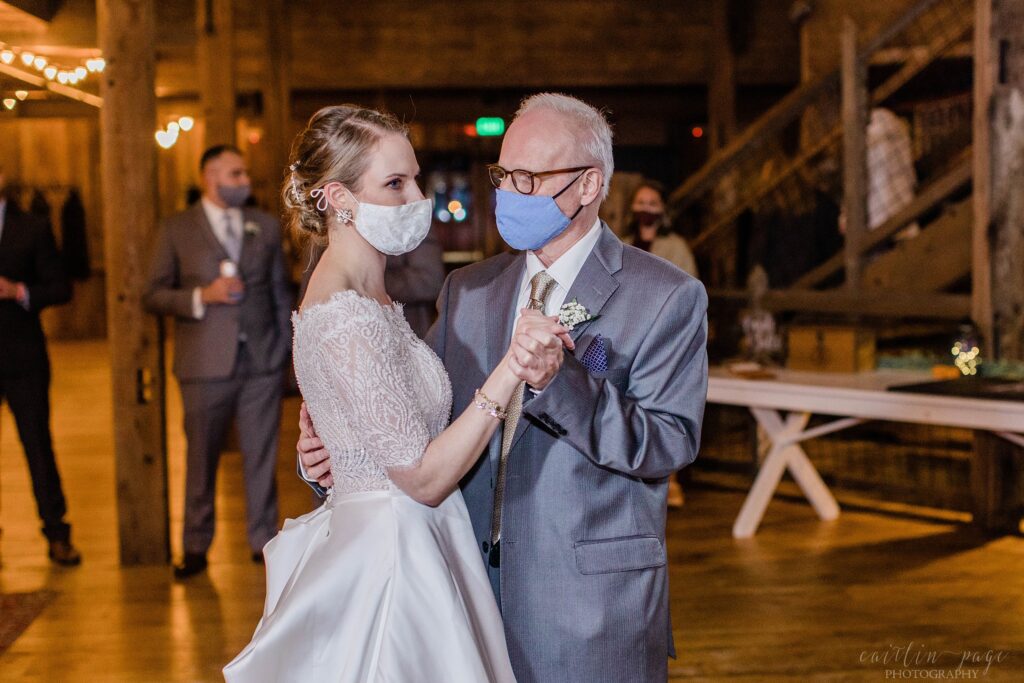 Bride and her father dancing in barn at wedding reception