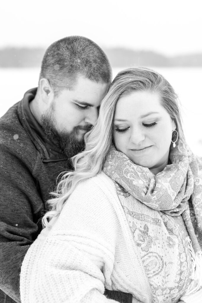 Black and white photo of couple snuggled together