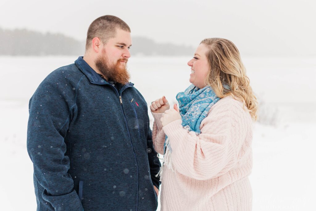 Man and woman at winter proposal in the snow