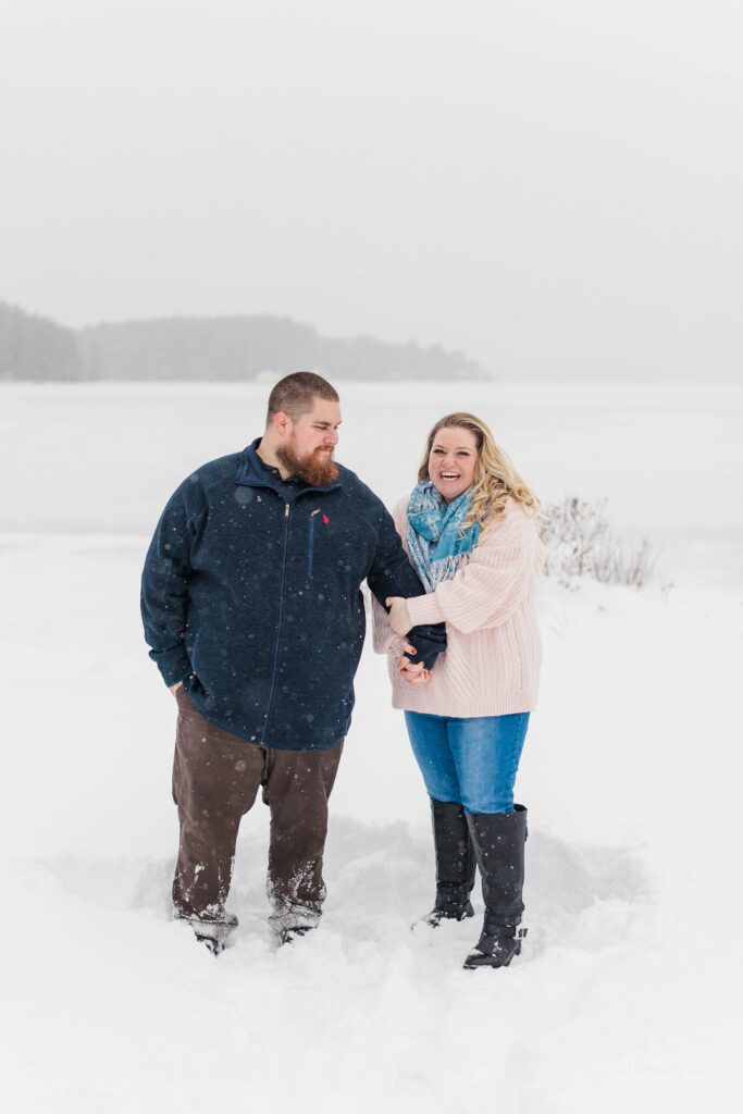 Man and woman laughing together in the snow