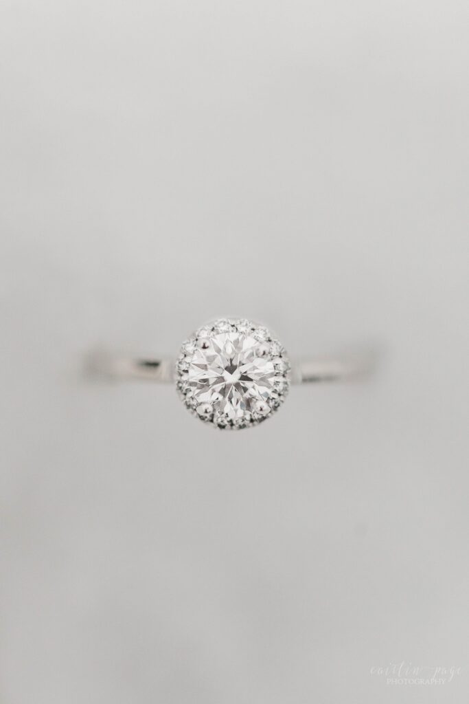 Solitaire engagement ring with halo in the snow