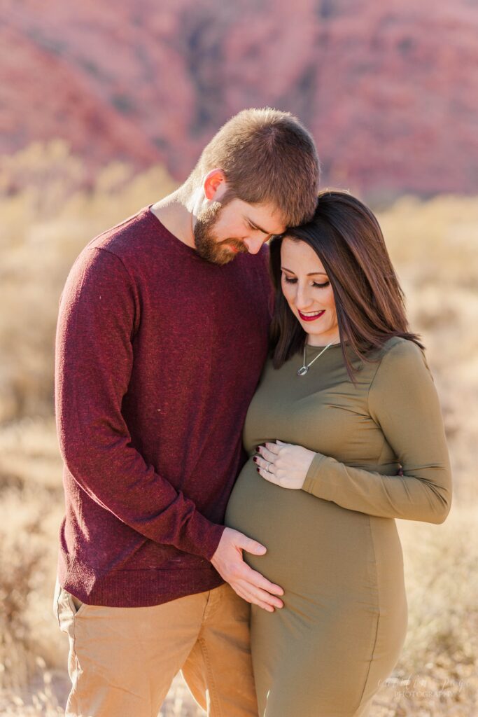 Man and woman looking at pregnant belly