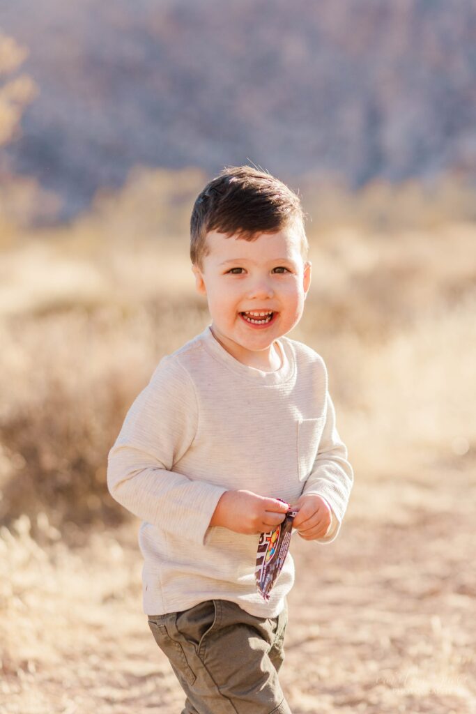 Little boy standing in the desert