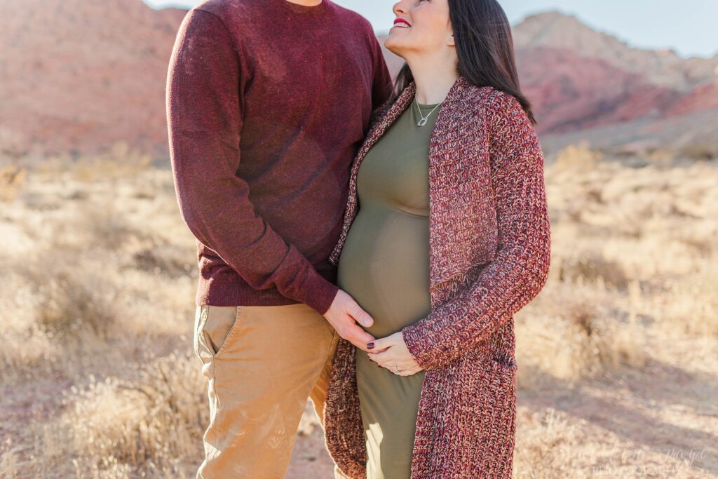 Man with his hand on pregnant woman's belly