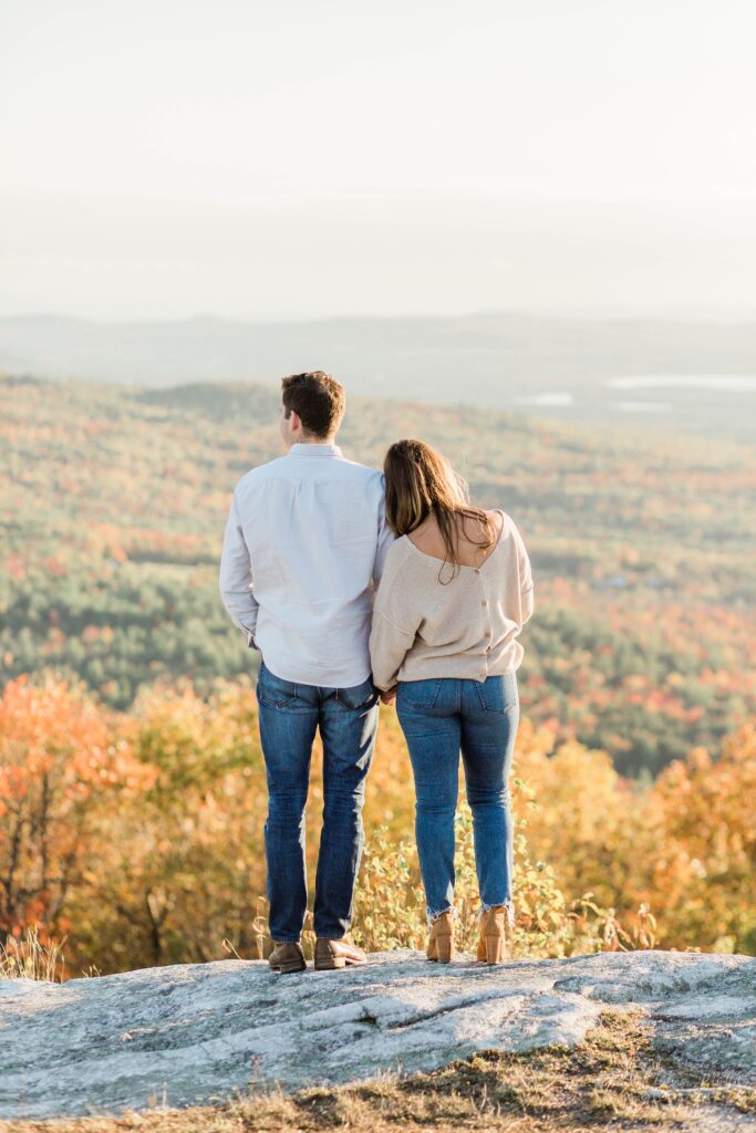 Man and woman standing together on the edge of mountaintop