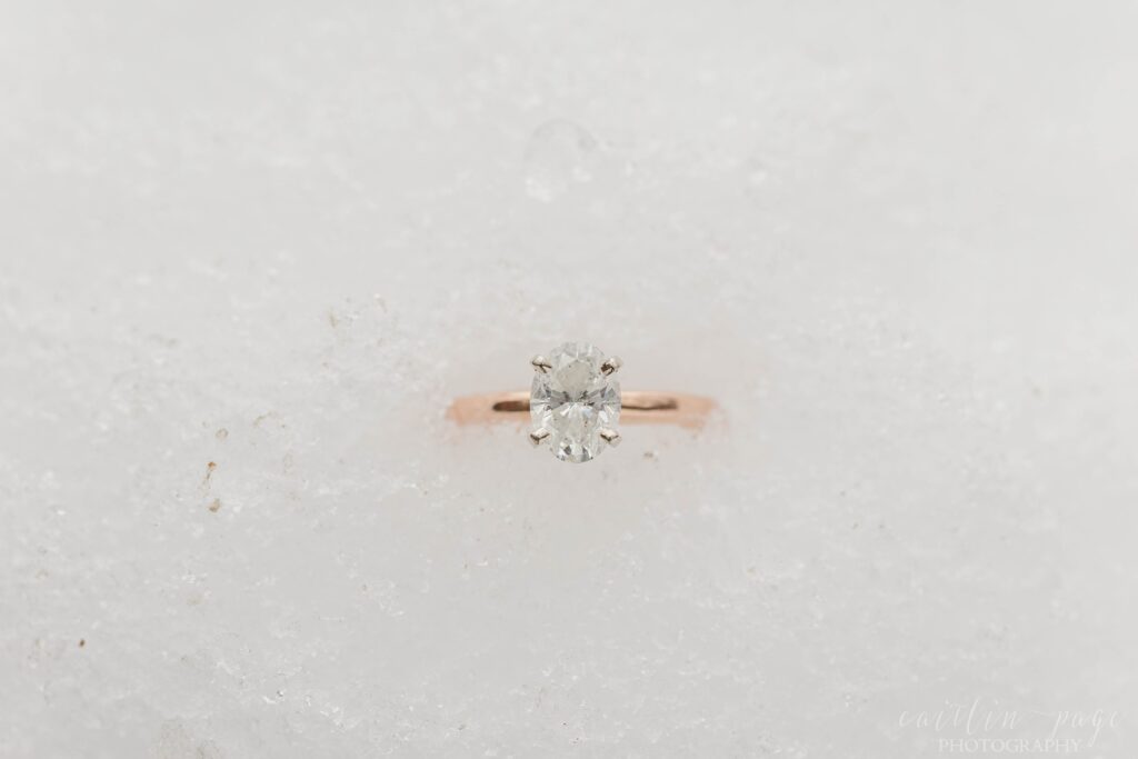 Oval solitaire engagement ring in the snow