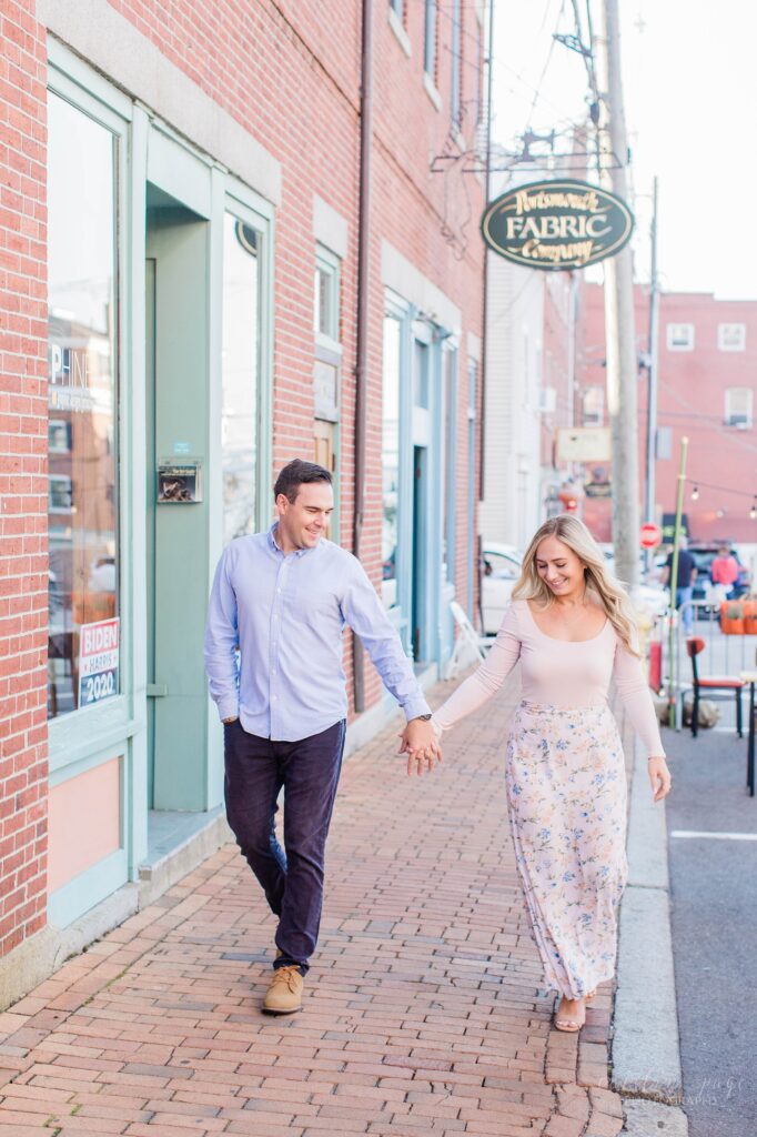 Couple walking down brick sidewalk