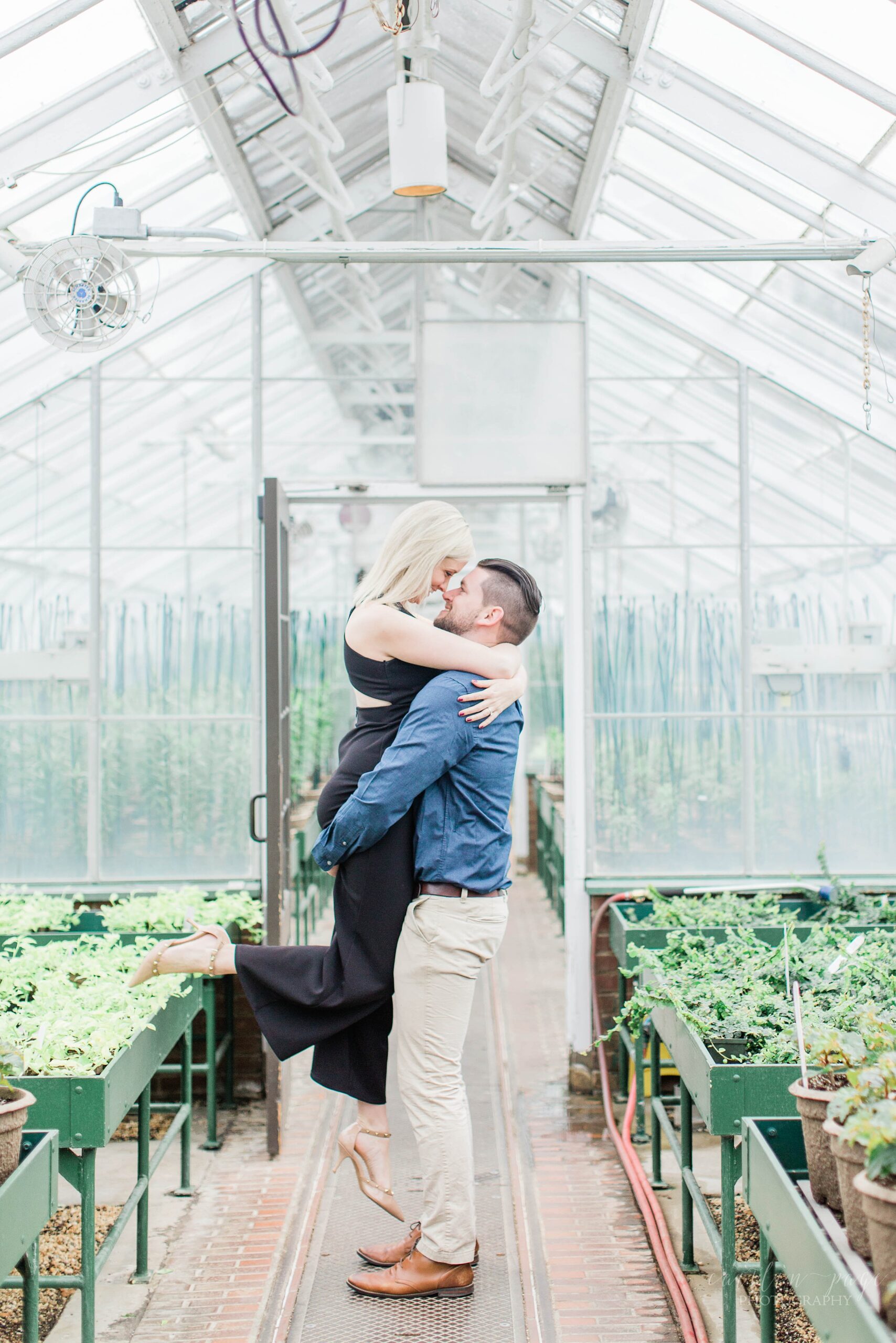 Man picking woman up in a greenhouse at Longwood Gardens