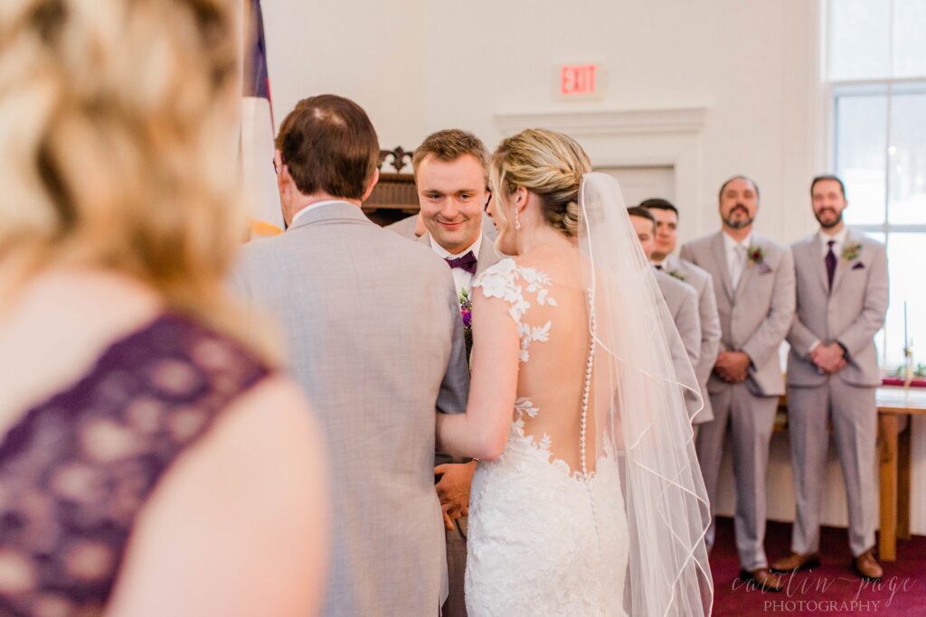 Groom looking at bride at altar
