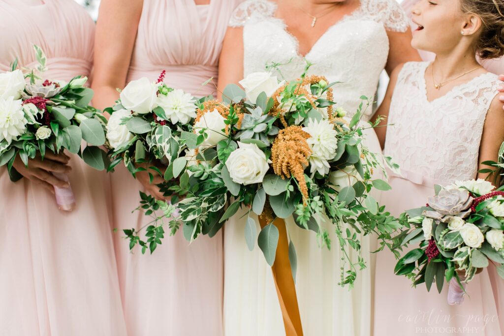 Bridesmaids and bride holding wedding bouquets