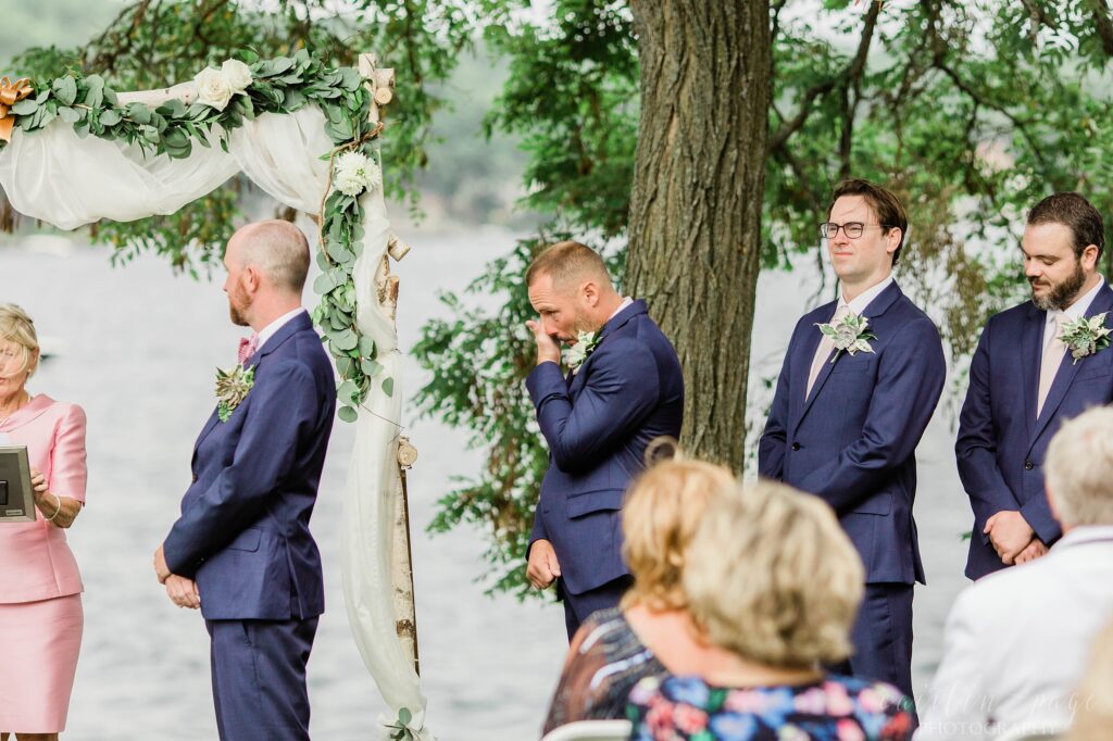 Groomsmen crying during wedding ceremony