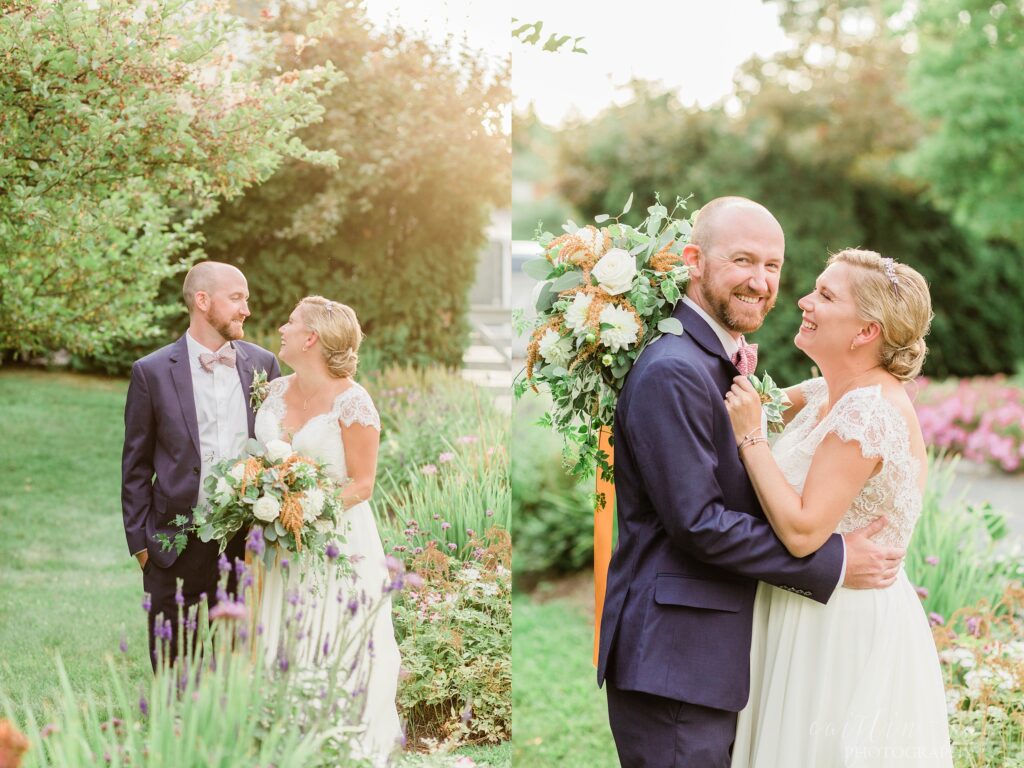Bride and groom standing outside in flower beds