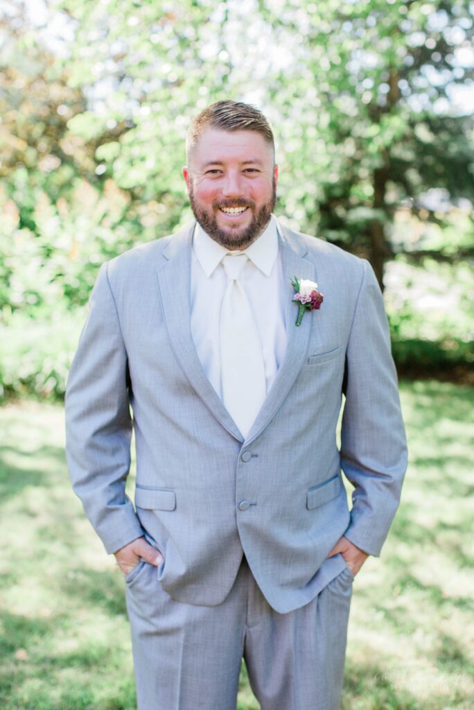 Groom standing with his hands in his pockets