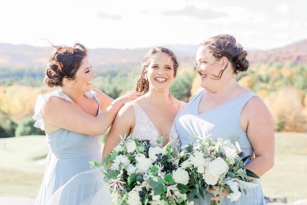Bridesmaids holding back brides hair