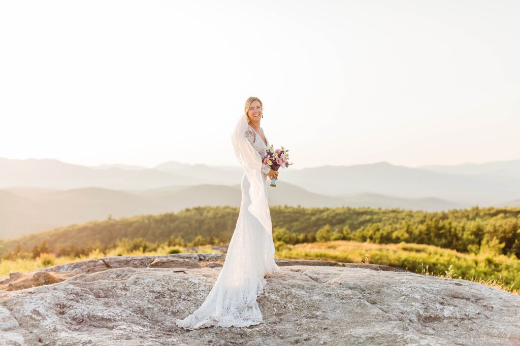 Bride standing at top of mountain