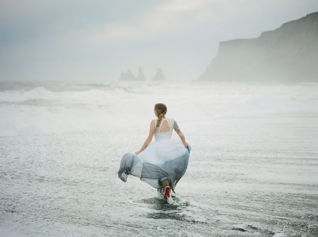 Woman running into the ocean