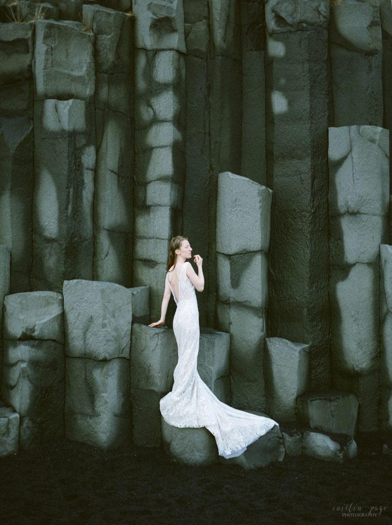 Woman standing on basalt cliffs in winter