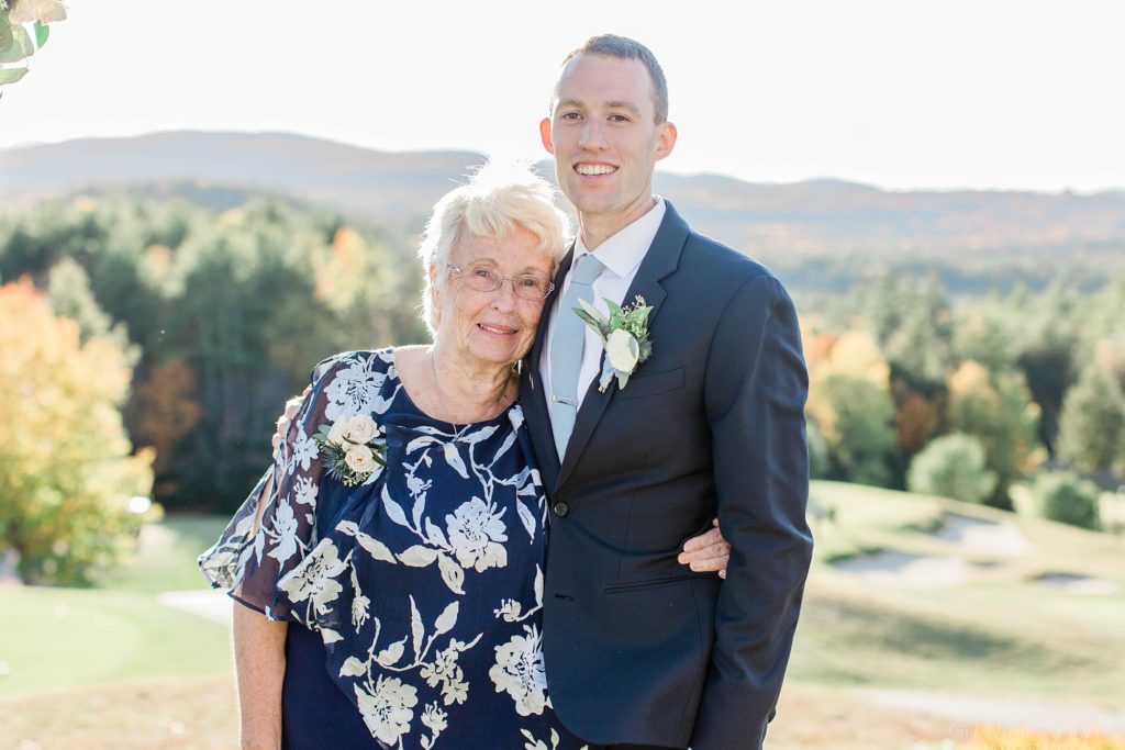 Groom and his grandmother standing in front of mountains