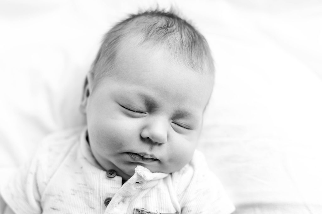 Black and white image of newborn baby boy