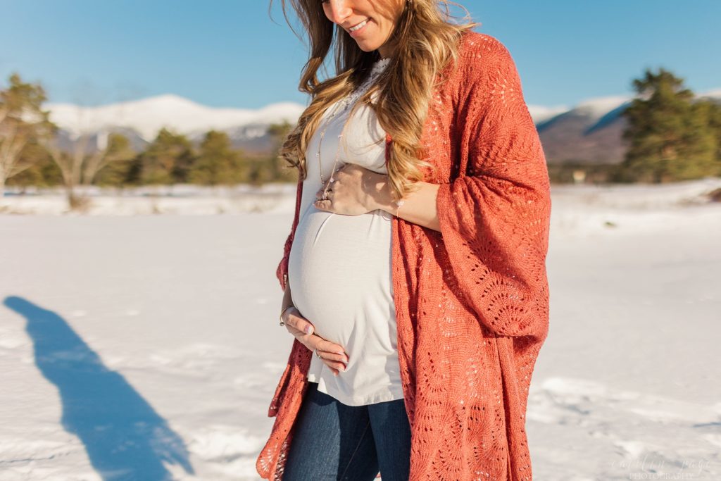 Pregnant woman standing in front of the mountains