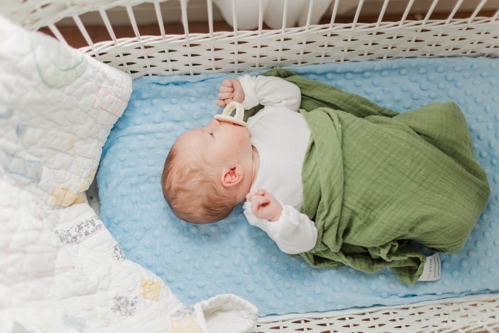 Newborn baby boy laying in crib