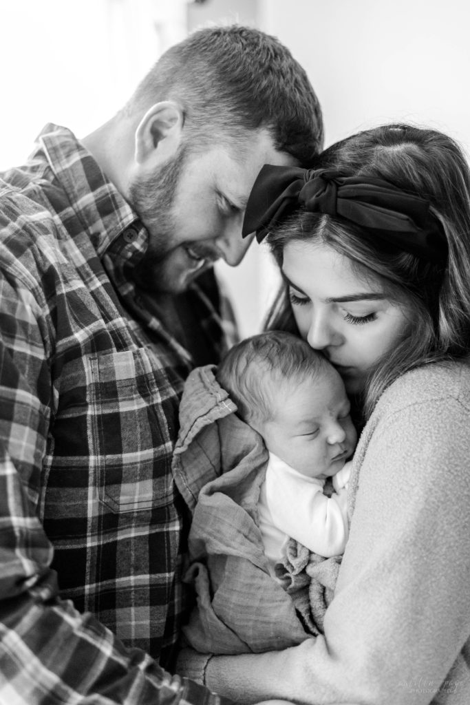 Parents holding newborn baby boy