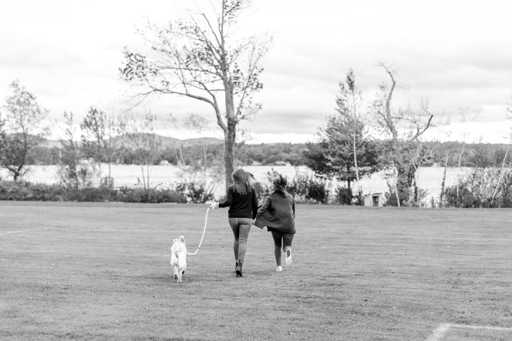 Lakeside fall engagement session at Lake Winnipesaukee with a puppy