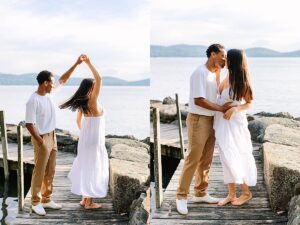 Man twirling his partner on a dock by the lake, both smiling as her dress flows in motion.