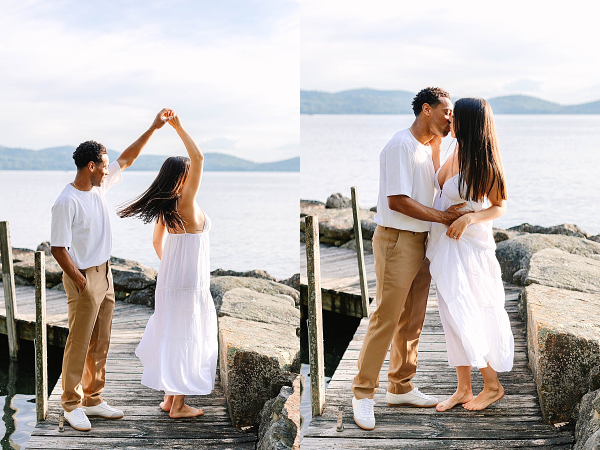 Man twirling his partner on a dock by the lake, both smiling as her dress flows in motion.